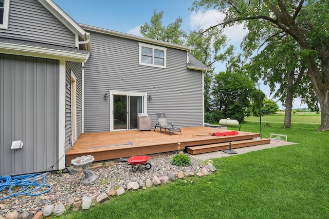 2256 40th Ave Unit X, East Farmington, WI 54020 - back of house with board and batten siding, a yard, and a wooden deck