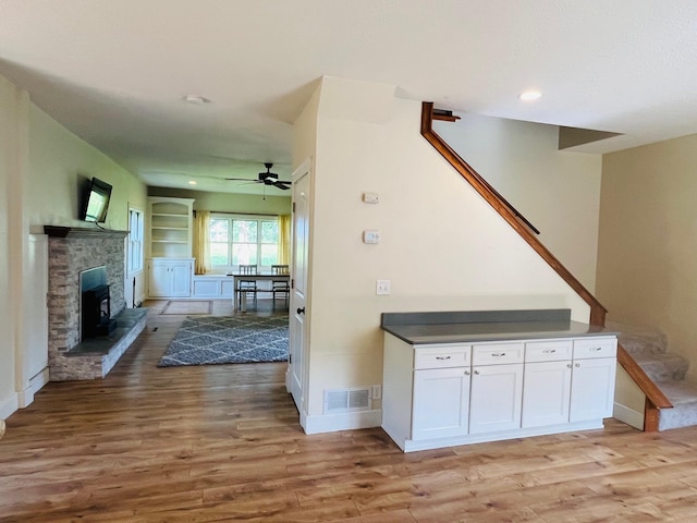 2256 40th Ave, East Farmington, WI 54020 - unfurnished living room with light wood-type flooring, ceiling fan, a fireplace, and recessed lighting