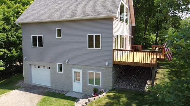 32813 Whispering Springs Loop, Erhard, MN 56534 - view of side of property featuring a garage, a shingled roof, a deck, and a yard