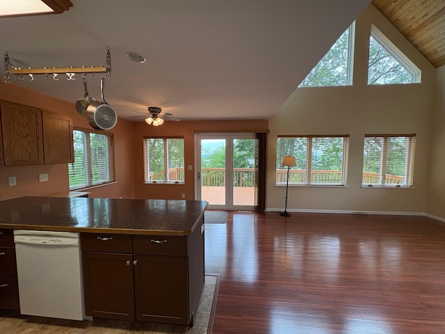 32813 Whispering Springs Loop, Erhard, MN 56534 - kitchen featuring white dishwasher, open floor plan, a peninsula, plenty of natural light, and lofted ceiling