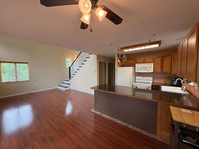 32813 Whispering Springs Loop, Erhard, MN 56534 - kitchen featuring white appliances, a peninsula, dark wood-style floors, ceiling fan, and open floor plan