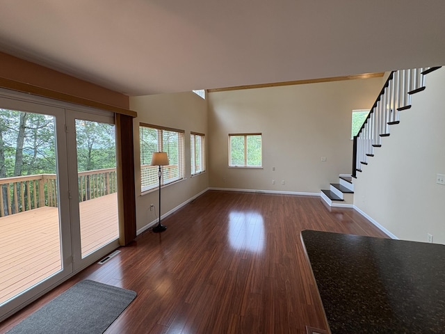 32813 Whispering Springs Loop, Erhard, MN 56534 - unfurnished living room featuring stairway and dark wood-style floors