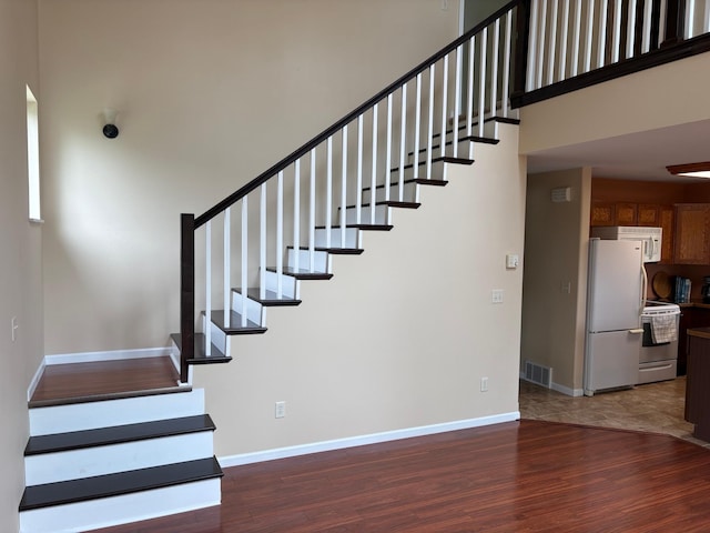 32813 Whispering Springs Loop, Erhard, MN 56534 - staircase featuring wood finished floors and a high ceiling