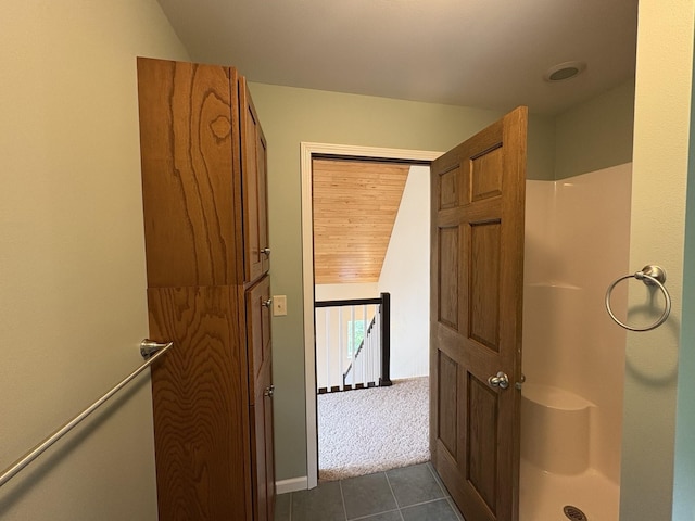 32813 Whispering Springs Loop, Erhard, MN 56534 - bathroom featuring tile patterned flooring, a shower, and vaulted ceiling