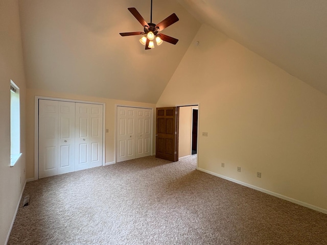 32813 Whispering Springs Loop, Erhard, MN 56534 - unfurnished bedroom with high vaulted ceiling, two closets, carpet, and ceiling fan