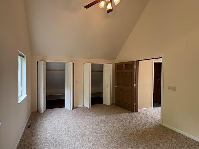 32813 Whispering Springs Loop, Erhard, MN 56534 - unfurnished bedroom with high vaulted ceiling, carpet flooring, multiple closets, and ceiling fan