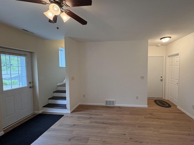 32813 Whispering Springs Loop, Erhard, MN 56534 - foyer with stairway, light wood-type flooring, and ceiling fan