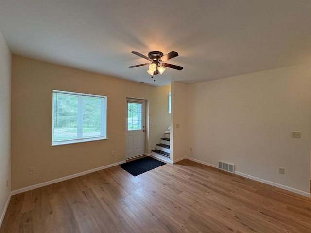 32813 Whispering Springs Loop, Erhard, MN 56534 - unfurnished living room featuring stairs, wood finished floors, and ceiling fan