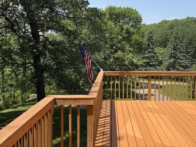 32813 Whispering Springs Loop, Erhard, MN 56534 - wooden deck with a wooded view and a yard
