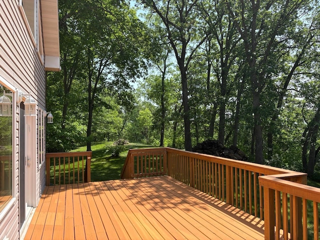 32813 Whispering Springs Loop, Erhard, MN 56534 - deck featuring view of wooded area