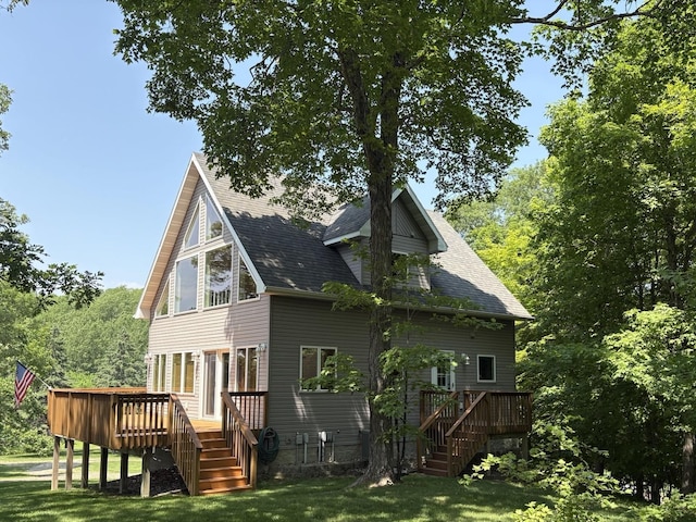 32813 Whispering Springs Loop, Erhard, MN 56534 - back of property featuring stairs, a wooden deck, a yard, and roof with shingles