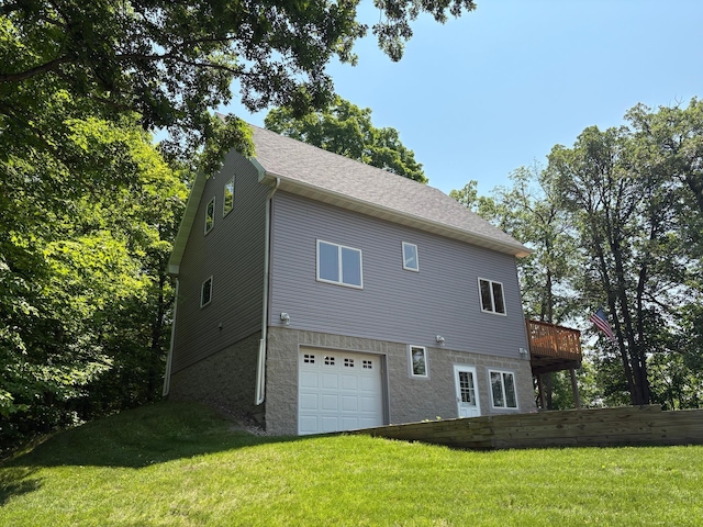 32813 Whispering Springs Loop, Erhard, MN 56534 - rear view of property featuring an attached garage, a lawn, and a wooden deck