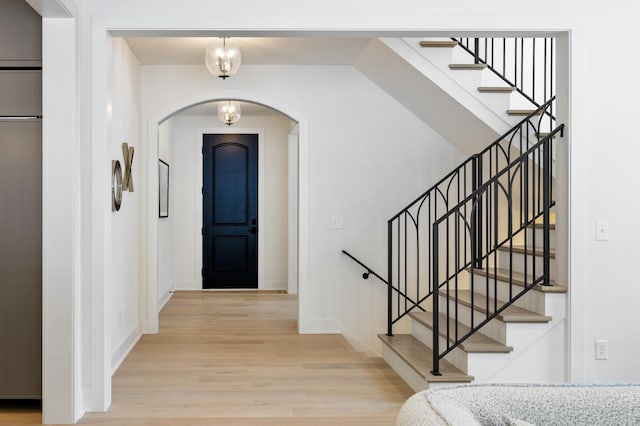 55XX Mcguire Rd, Edina, MN 55439 - foyer featuring arched walkways, wood finished floors, and stairs