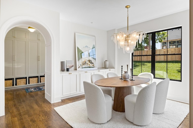 55XX Mcguire Rd, Edina, MN 55439 - dining space featuring a chandelier, dark wood-style flooring, and arched walkways