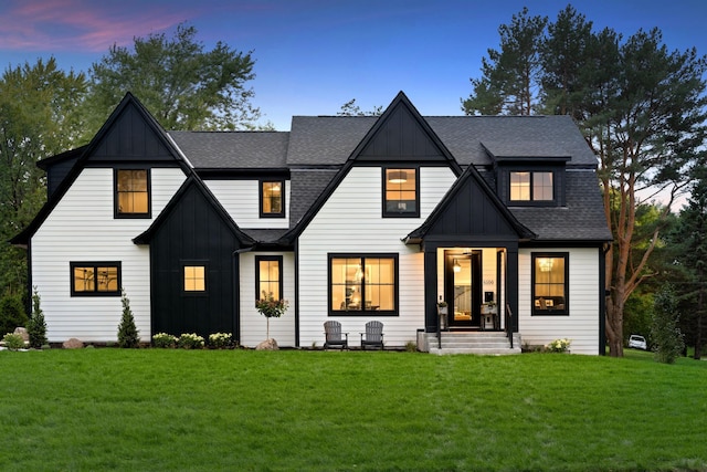55XX Mcguire Rd, Edina, MN 55439 - modern inspired farmhouse with board and batten siding, a shingled roof, and a lawn
