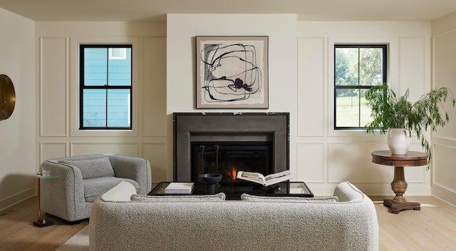 55XX Mcguire Rd, Edina, MN 55439 - living area with wood finished floors, a glass covered fireplace, and a decorative wall