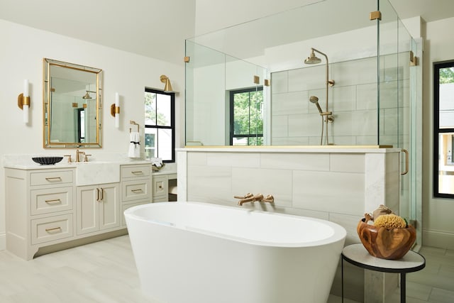 55XX Mcguire Rd, Edina, MN 55439 - bathroom featuring healthy amount of natural light, a freestanding bath, and a shower stall