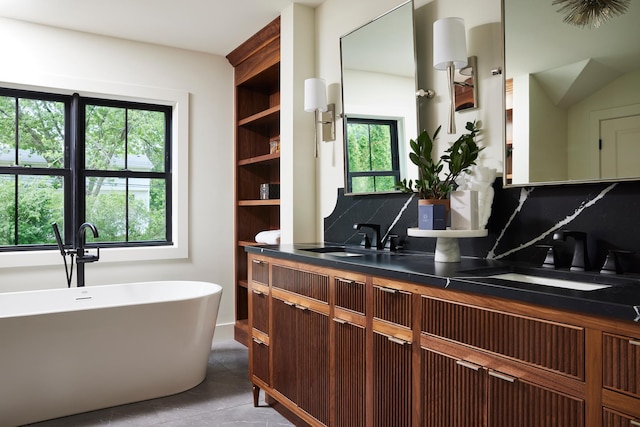 55XX Mcguire Rd, Edina, MN 55439 - full bathroom featuring backsplash, double vanity, a soaking tub, and tile patterned flooring