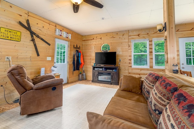 6076 Wynne Ridge Rd, White Twp, MN 55705 - living room featuring healthy amount of natural light, wood walls, and a ceiling fan