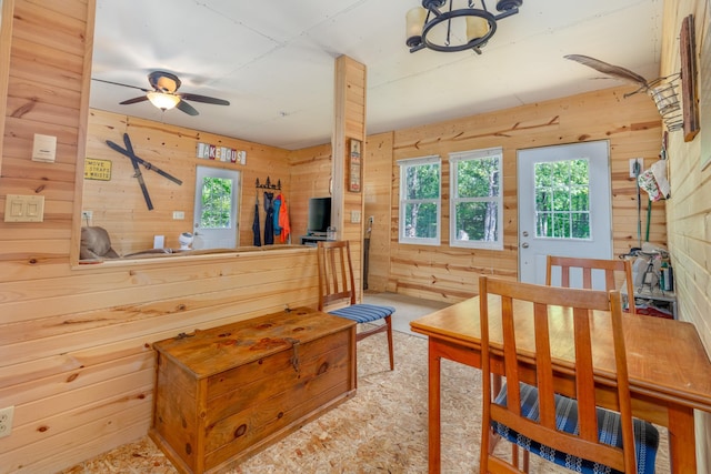 6076 Wynne Ridge Rd, White Twp, MN 55705 - dining space with wooden walls, plenty of natural light, carpet floors, and a ceiling fan