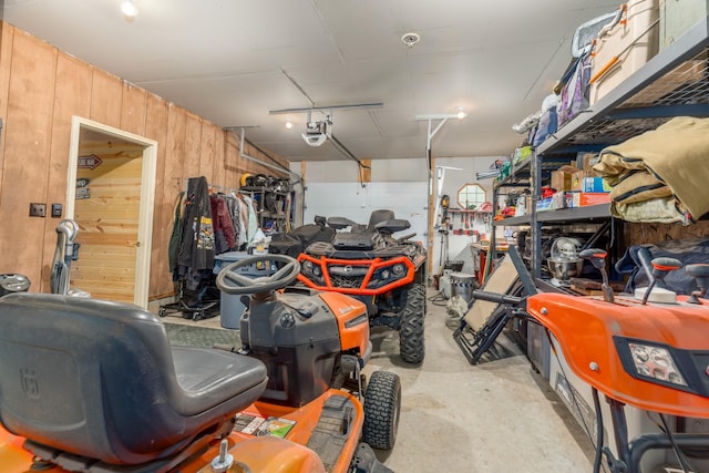 6076 Wynne Ridge Rd, White Twp, MN 55705 - garage featuring a garage door opener and wood walls