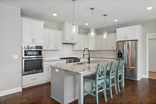 15827 Ethan Trl N, Hugo, MN 55038 - kitchen with stainless steel appliances, a sink, dark wood finished floors, backsplash, and recessed lighting