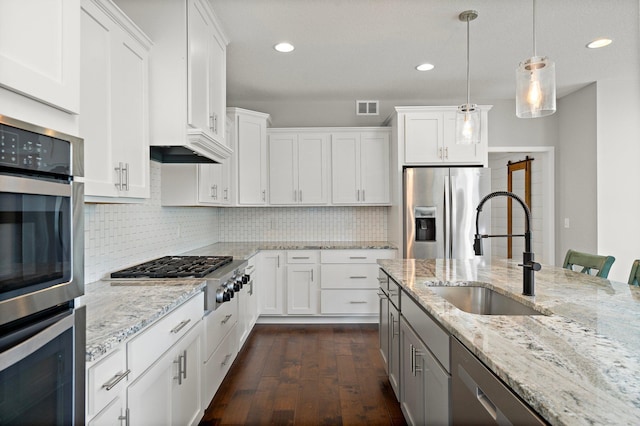 15827 Ethan Trl N, Hugo, MN 55038 - kitchen with appliances with stainless steel finishes, a sink, dark wood-style flooring, white cabinets, and recessed lighting