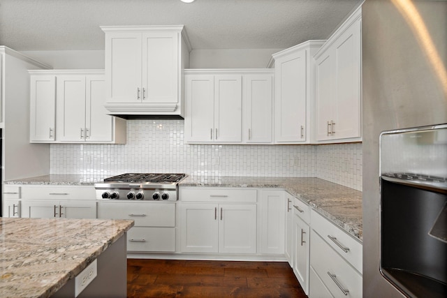15827 Ethan Trl N, Hugo, MN 55038 - kitchen with freestanding refrigerator, stainless steel gas cooktop, dark wood-style flooring, white cabinetry, and a textured ceiling
