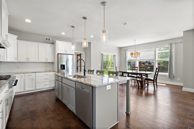 15827 Ethan Trl N, Hugo, MN 55038 - kitchen featuring appliances with stainless steel finishes, a sink, plenty of natural light, a chandelier, and recessed lighting