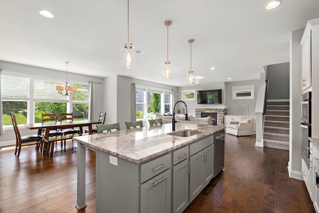 15827 Ethan Trl N, Hugo, MN 55038 - kitchen with a sink, a stone fireplace, open floor plan, recessed lighting, and dark wood-type flooring