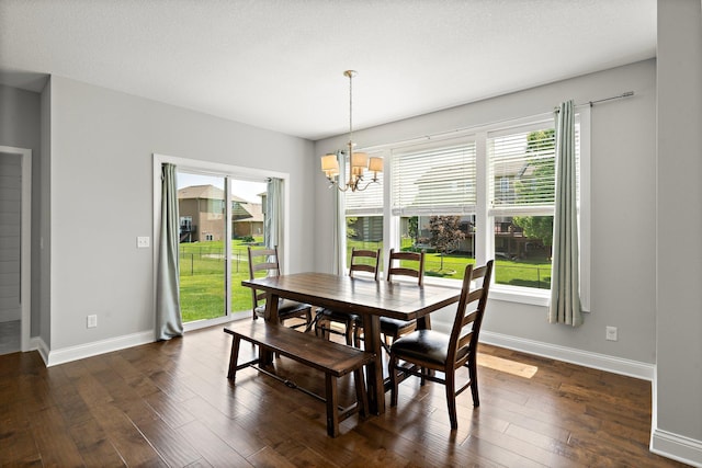 15827 Ethan Trl N, Hugo, MN 55038 - dining area with a chandelier, dark wood-type flooring, and baseboards