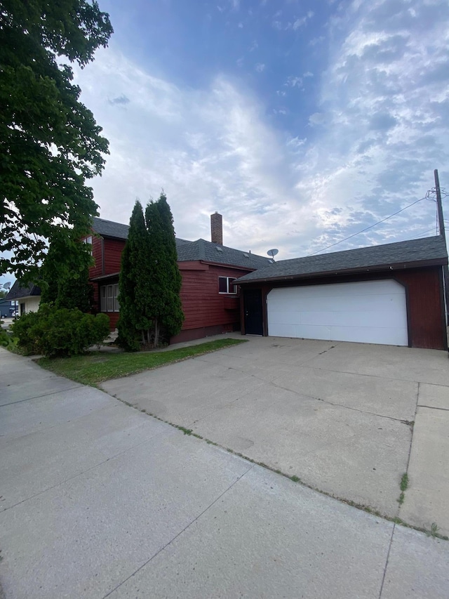 8 Dayton Ave SE, Wadena, MN 56482 - view of front of home featuring driveway, a chimney, and a garage
