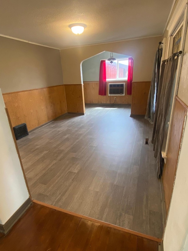 8 Dayton Ave SE, Wadena, MN 56482 - spare room featuring a wainscoted wall, wood walls, wood finished floors, and a wall mounted AC