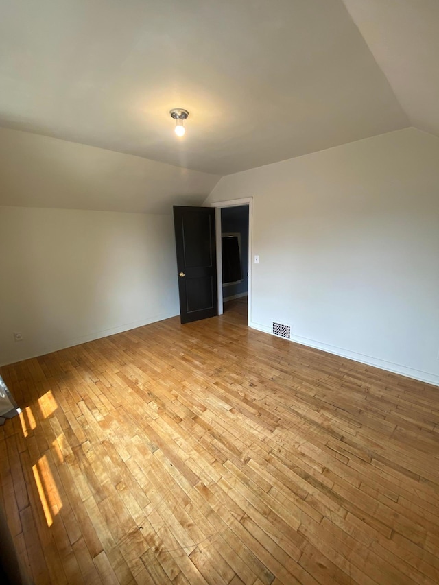 8 Dayton Ave SE, Wadena, MN 56482 - spare room with lofted ceiling, light wood-style floors, and baseboards