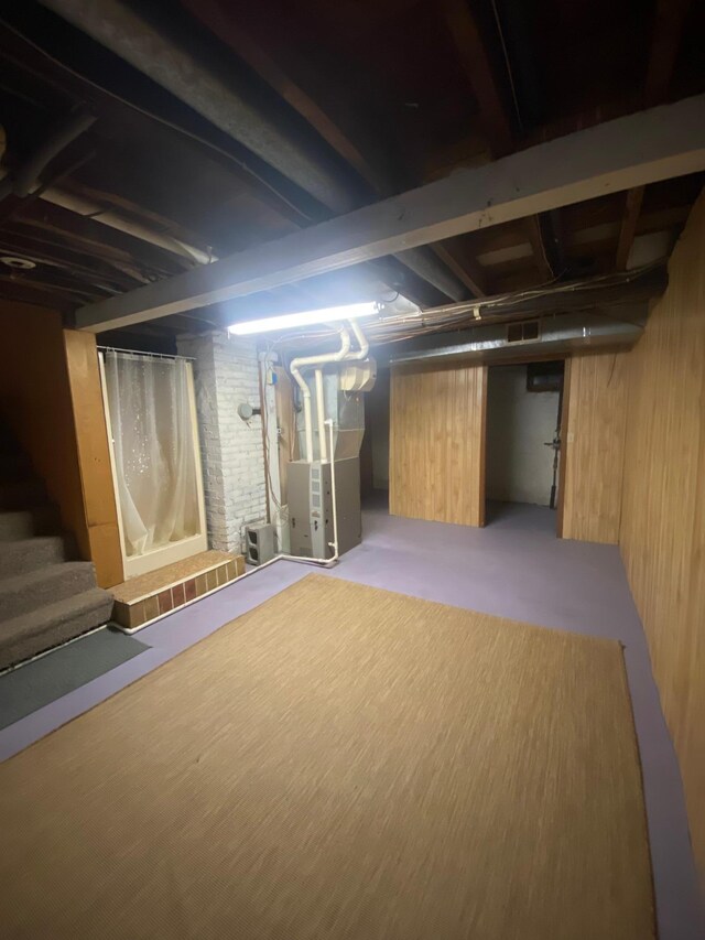 8 Dayton Ave SE, Wadena, MN 56482 - finished below grade area featuring wooden walls, heating unit, and stairway