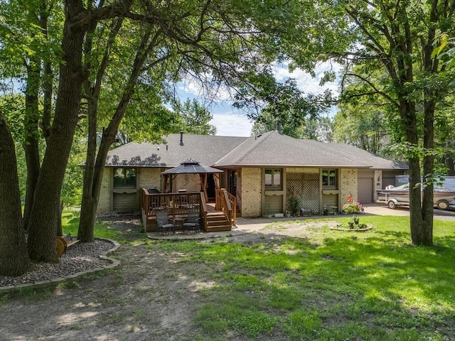 18241 Dahlia St NW, Oak Grove, MN 55011 - view of front facade featuring a garage, a gazebo, a front lawn, brick siding, and driveway