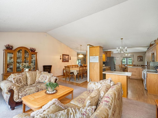 18241 Dahlia St NW, Oak Grove, MN 55011 - living area with vaulted ceiling, a chandelier, and light wood finished floors