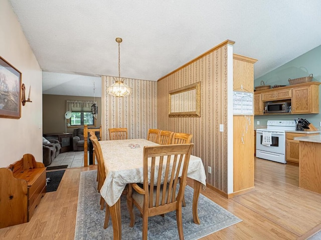 18241 Dahlia St NW, Oak Grove, MN 55011 - dining space with a chandelier, light wood-style floors, and wallpapered walls