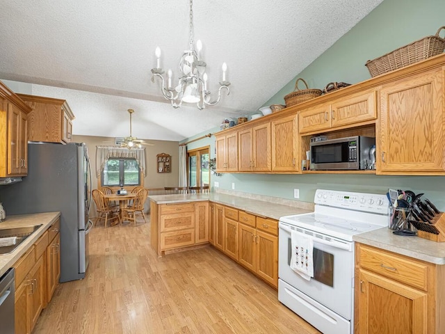 18241 Dahlia St NW, Oak Grove, MN 55011 - kitchen with stainless steel appliances, lofted ceiling, ceiling fan, a textured ceiling, and a peninsula
