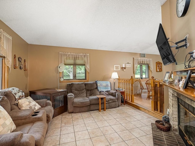 18241 Dahlia St NW, Oak Grove, MN 55011 - living room featuring healthy amount of natural light, a textured ceiling, light tile patterned floors, and a fireplace