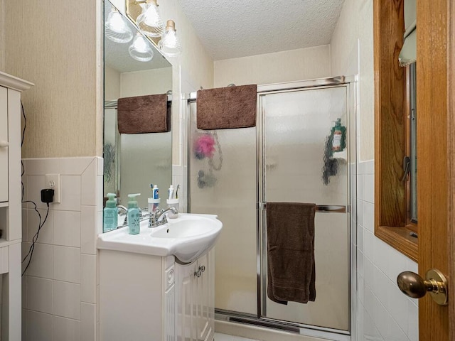 18241 Dahlia St NW, Oak Grove, MN 55011 - bathroom featuring vanity, a stall shower, and a textured ceiling