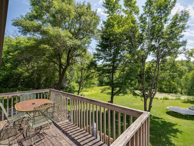 18241 Dahlia St NW, Oak Grove, MN 55011 - wooden deck with a trampoline, outdoor dining area, a yard, and area for grilling