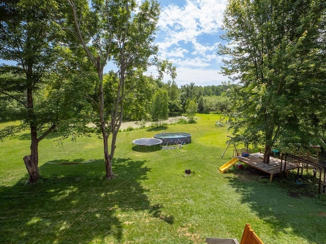 18241 Dahlia St NW, Oak Grove, MN 55011 - view of grassy yard featuring a trampoline
