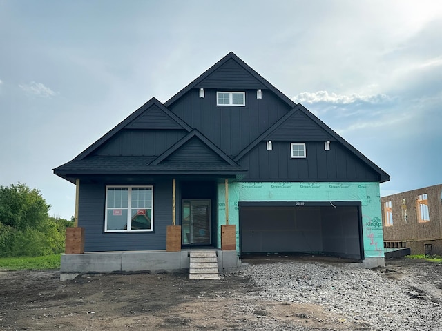 20119 68th Pl, Corcoran, MN 55340 - view of front of property featuring board and batten siding, a garage, and covered porch