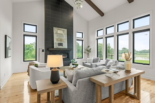 9743 Frontier Ln, Lakeville, MN 55044 - living room with high vaulted ceiling, a fireplace, light wood-style floors, and beamed ceiling