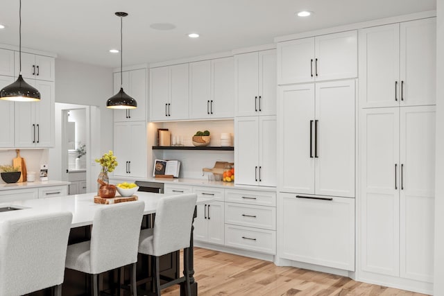 9743 Frontier Ln, Lakeville, MN 55044 - kitchen with light countertops, white cabinetry, recessed lighting, pendant lighting, and light wood-type flooring