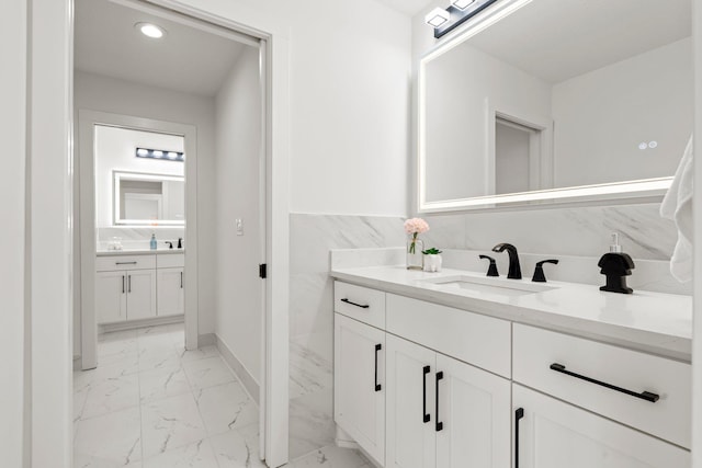 9743 Frontier Ln, Lakeville, MN 55044 - bathroom featuring marble finish floors, two vanities, and recessed lighting