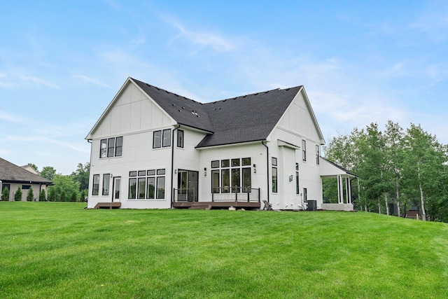 9743 Frontier Ln, Lakeville, MN 55044 - rear view of property with board and batten siding, a lawn, and a shingled roof