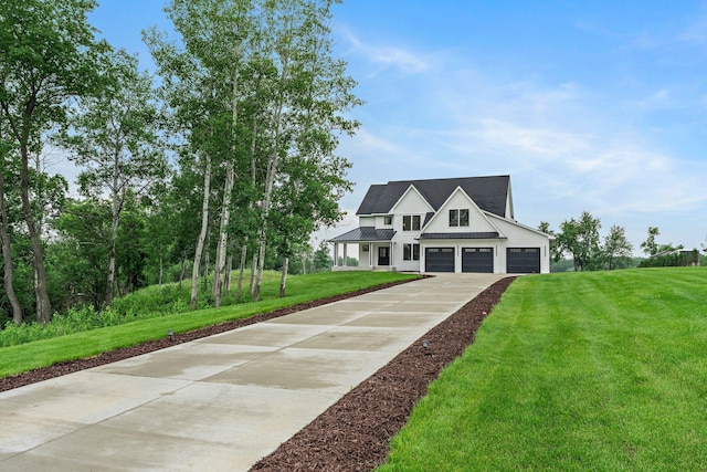9743 Frontier Ln, Lakeville, MN 55044 - modern farmhouse featuring driveway, a front lawn, a standing seam roof, a garage, and a metal roof