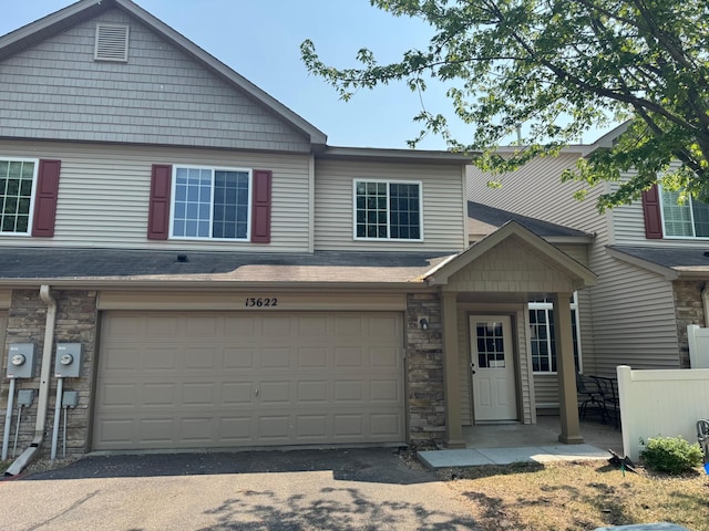 13622 Partridge Cir NW, Andover, MN 55304 - multi unit property with stone siding, a garage, and driveway